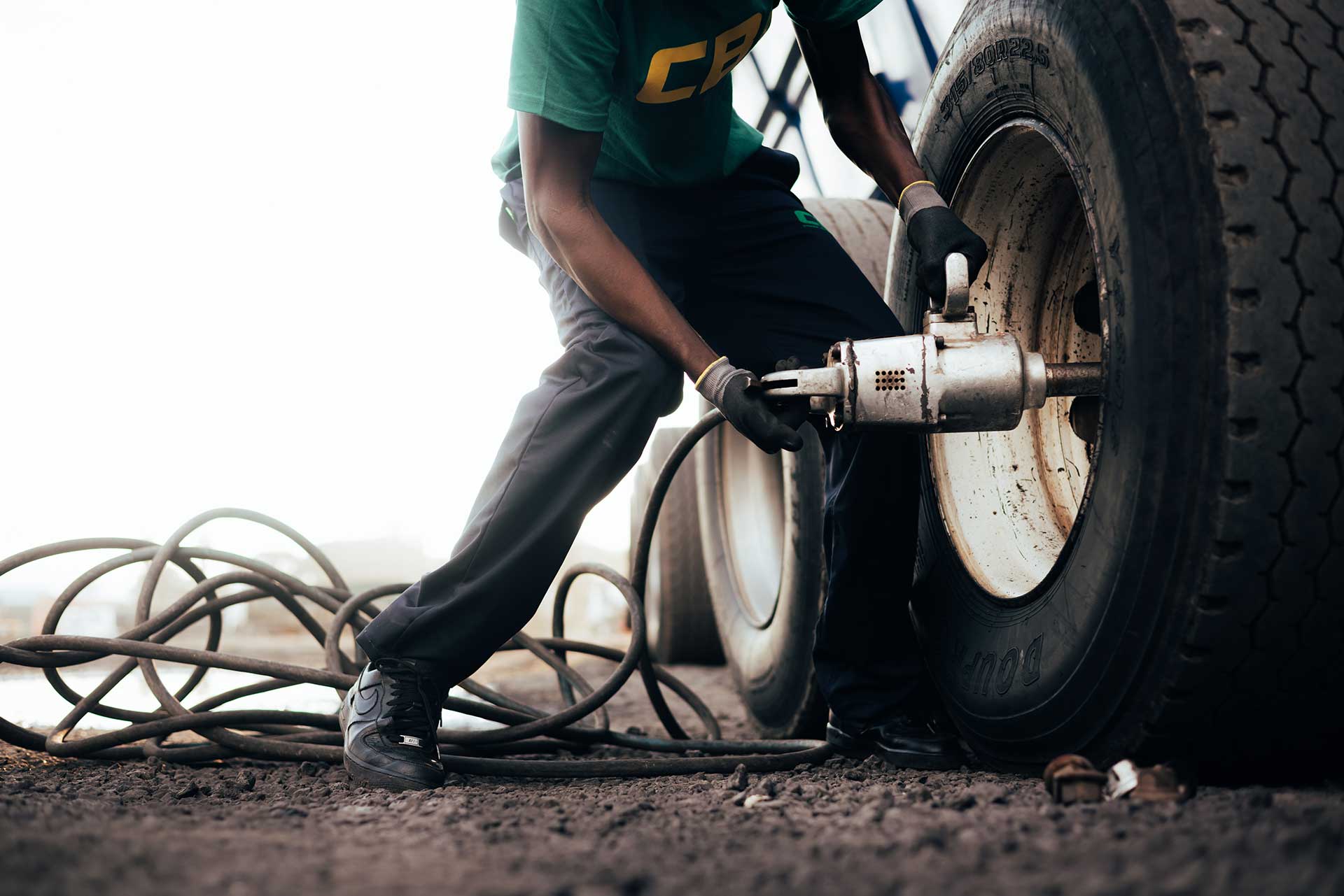 closeup of a technician changing a truck tyre