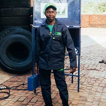 technician standing holding a toolbox