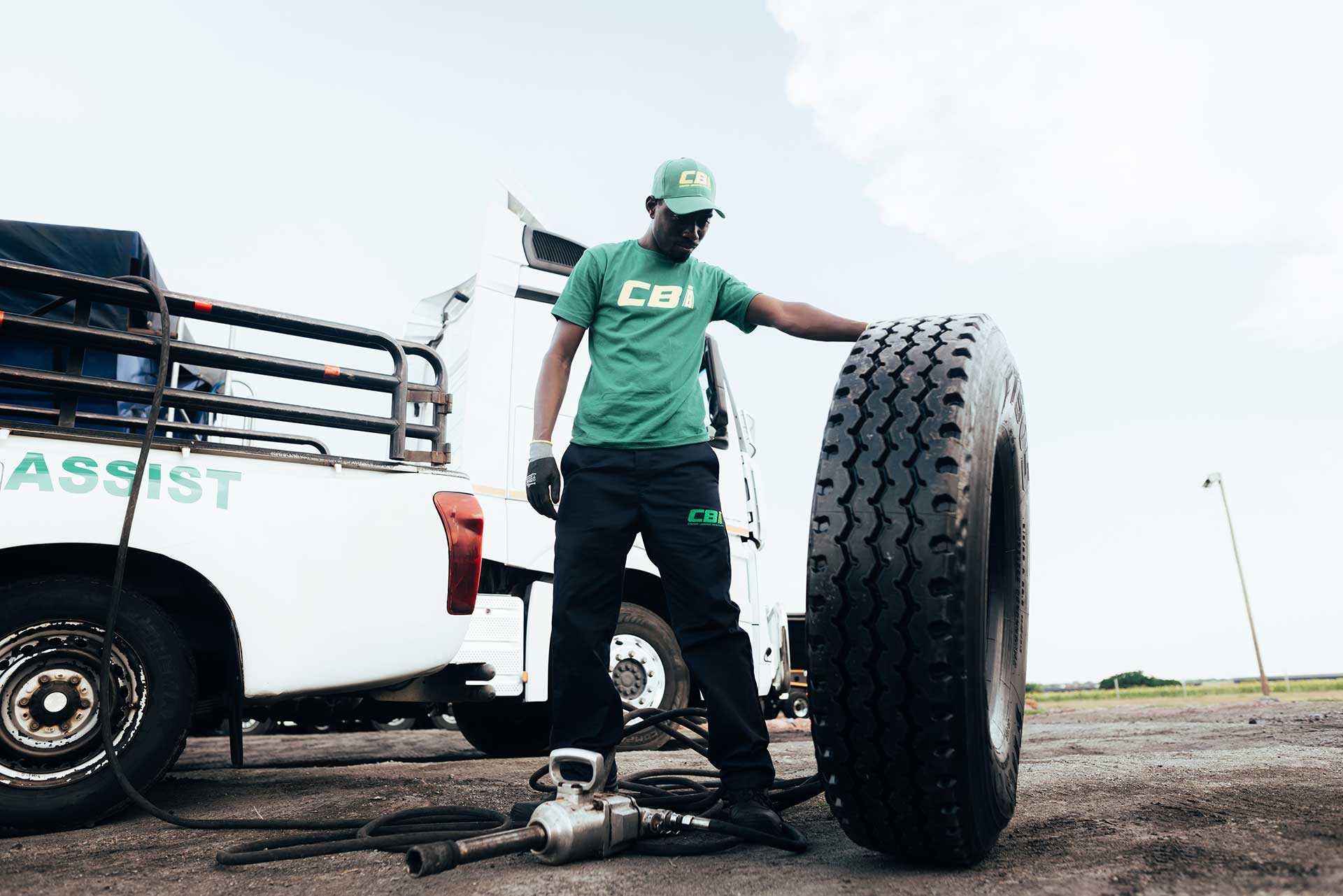 technician holding a tyre near a van