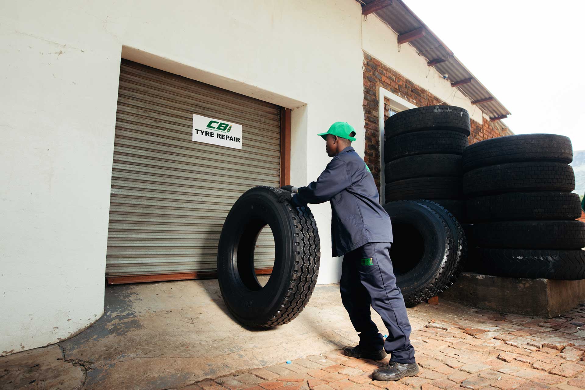technician rolling a truck tyre