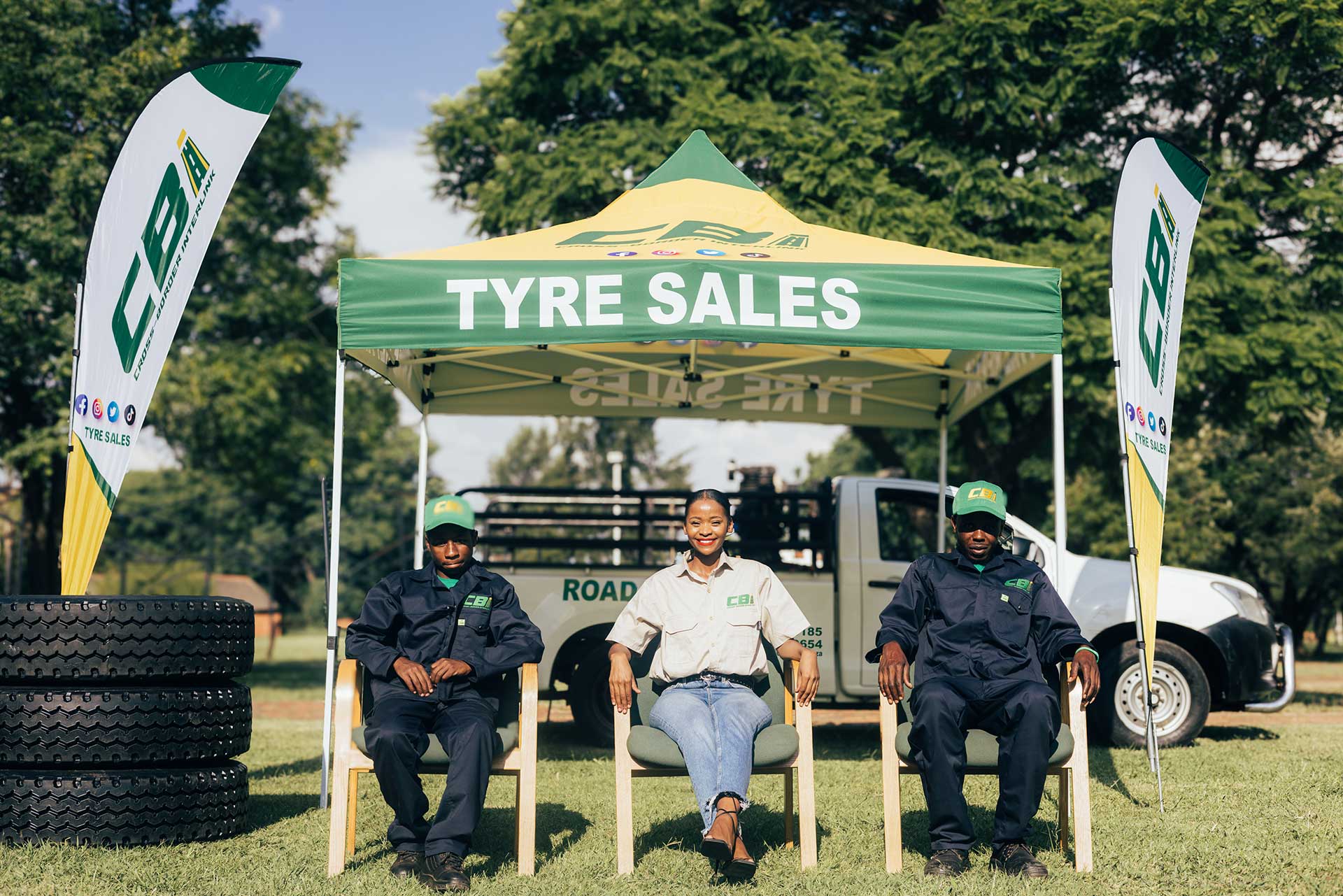 three CBI employees sitting under a gazebo